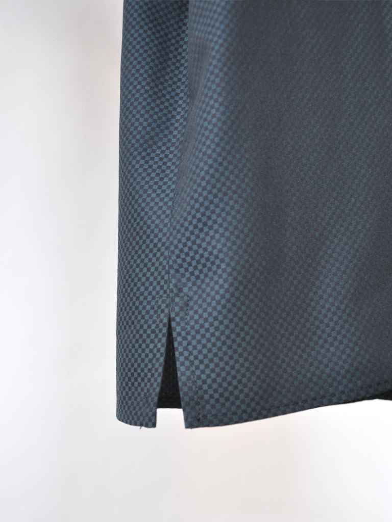 Closeup of Aia top in black and green check