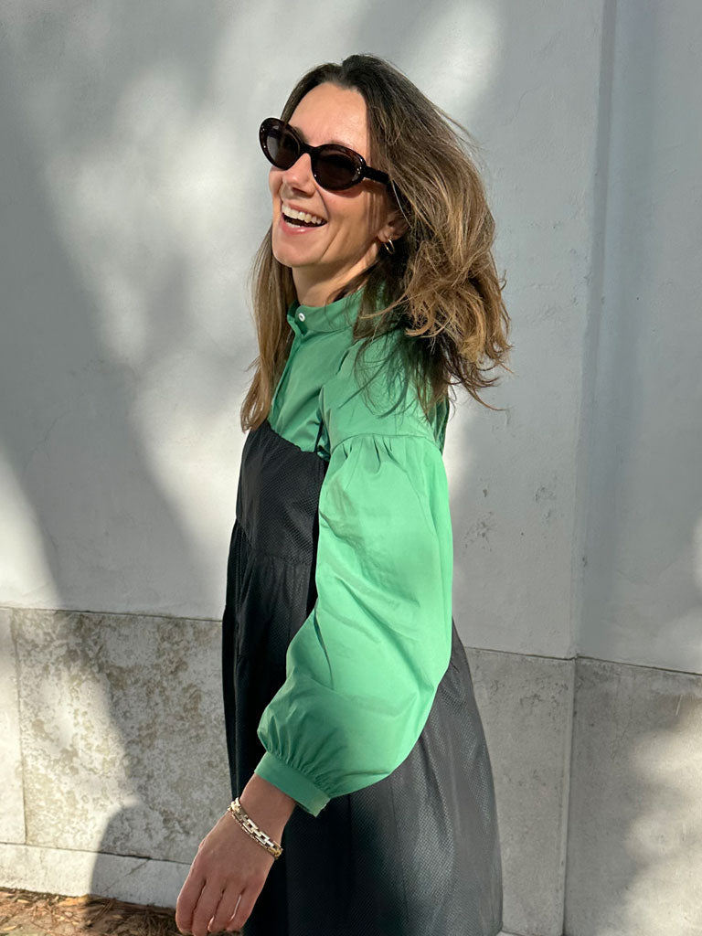 Side of Aude shirt in green under Astis dress