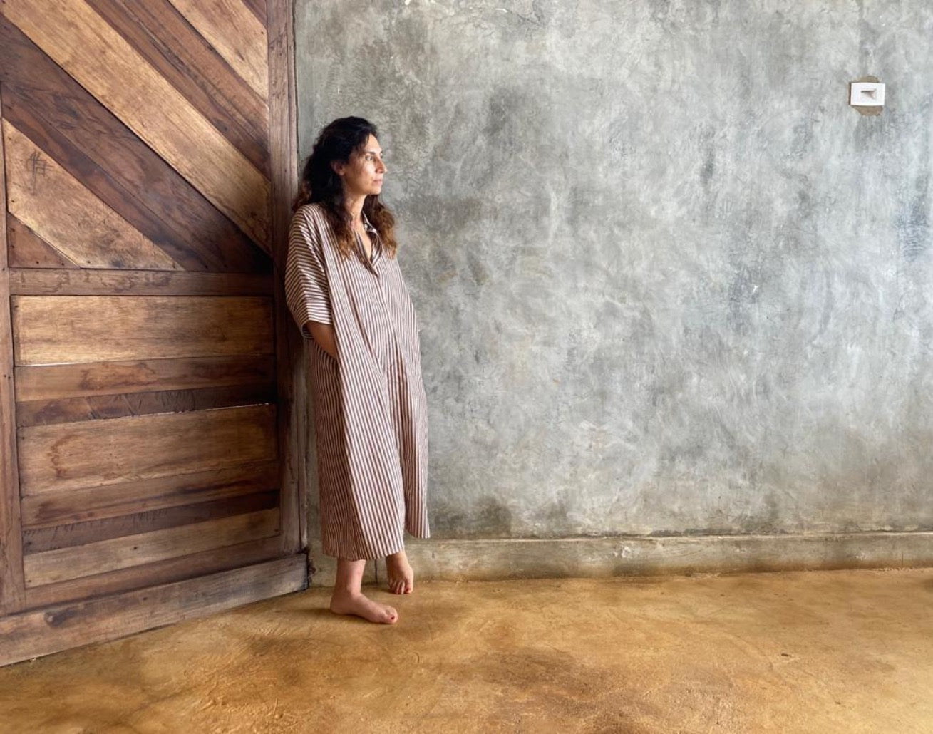 Casual shot of beige and aubergine striped dress