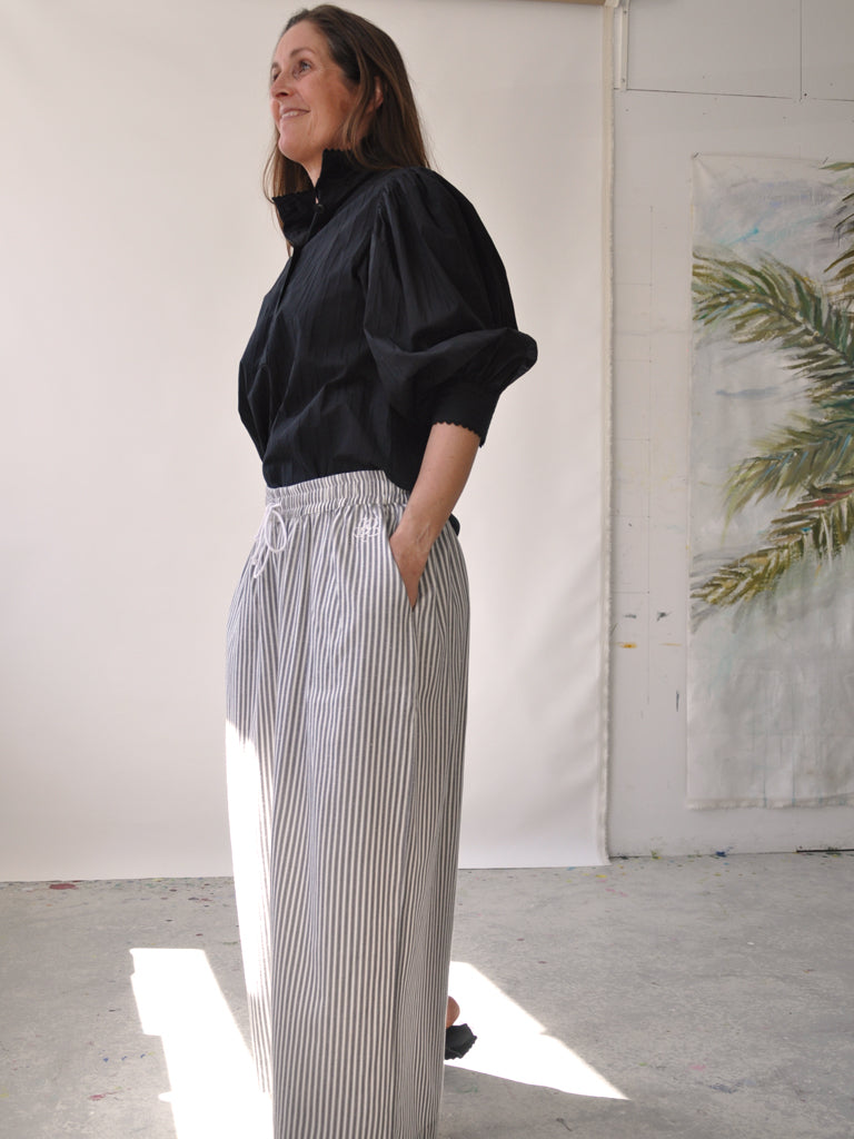 Side of Elisa pants in grey stripes