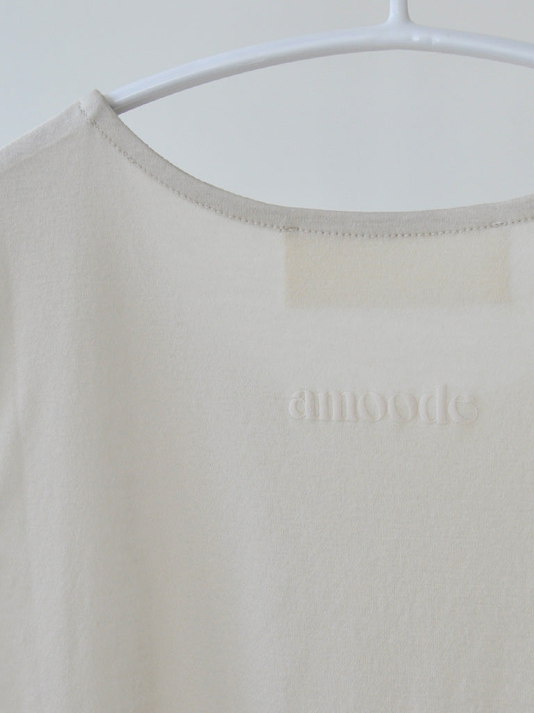 Logo Closeup of Aniset Top in Soft Beige on a hanger