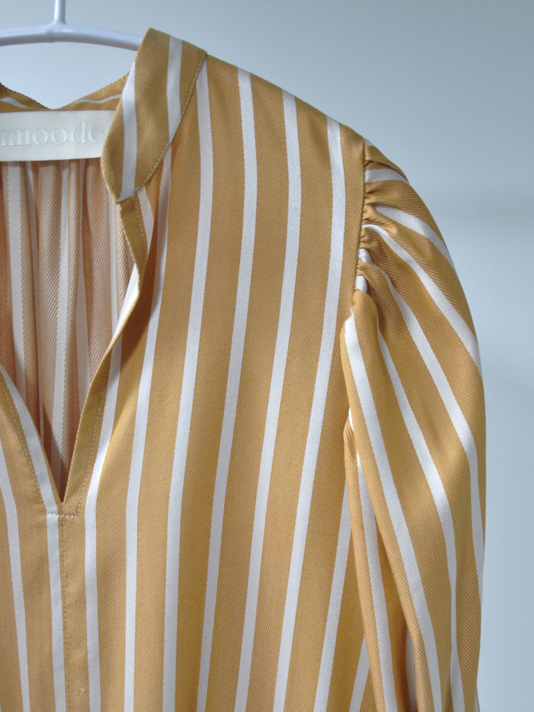 Neck and Shoulder Closeup of Arona Dress in Ochre Stripes on a hanger