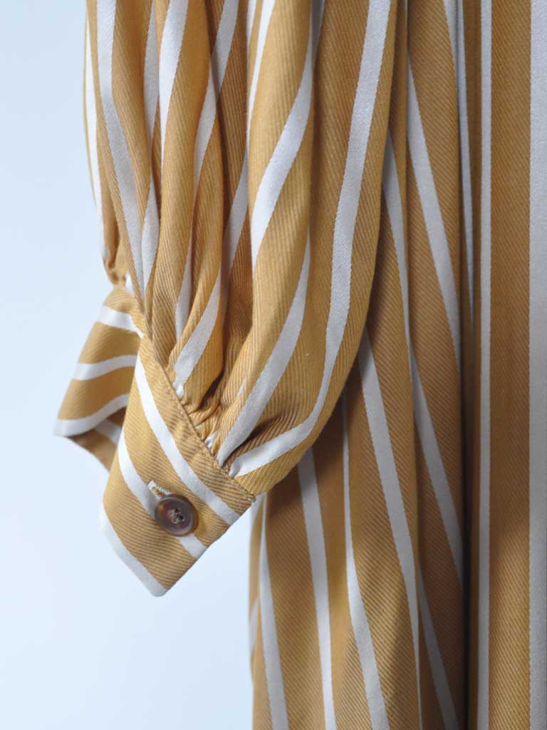 Sleeve Closeup of Arona Dress in Ochre Stripes on a hanger