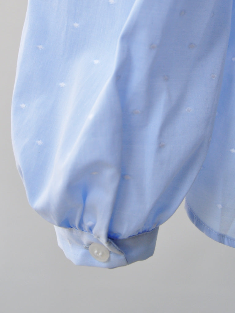 Balloon Sleeve Closeup of Aude Shirt in Blue on a hanger