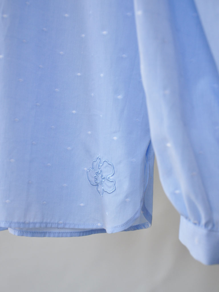 Detail Closeup of Aude Shirt in Blue on a hanger