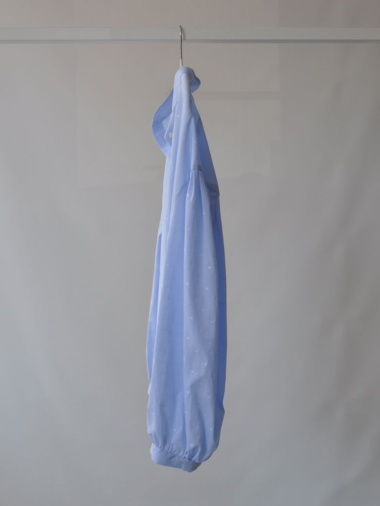 Side of Aude Shirt in Blue on a hanger