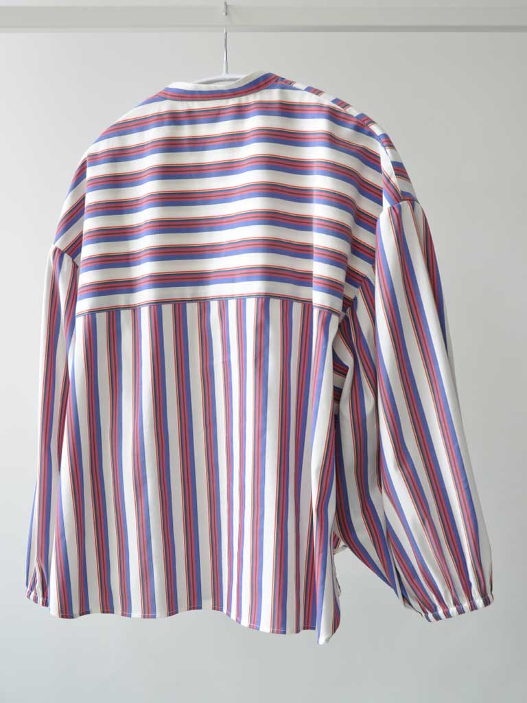 Back of Elli Shirt in Magenta Stripes on a hanger