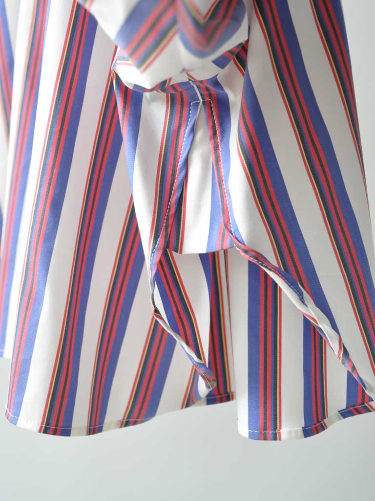 Detail Closeup of Elli Shirt in Magenta Stripes on a hanger