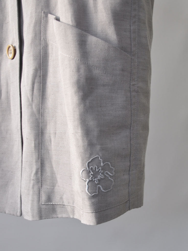 Pocket Closeup of Etna Linen Vest in Grey with Embroidered Flower