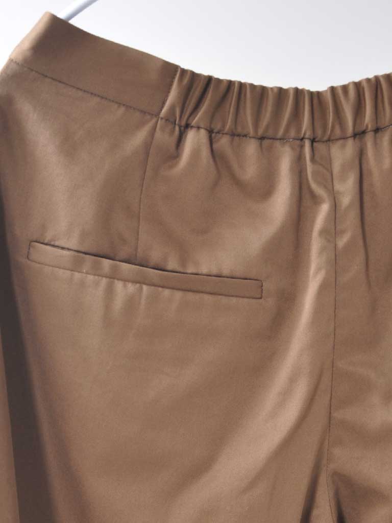 Back Pocket Closeup of Studio Pleats Pants in Brown