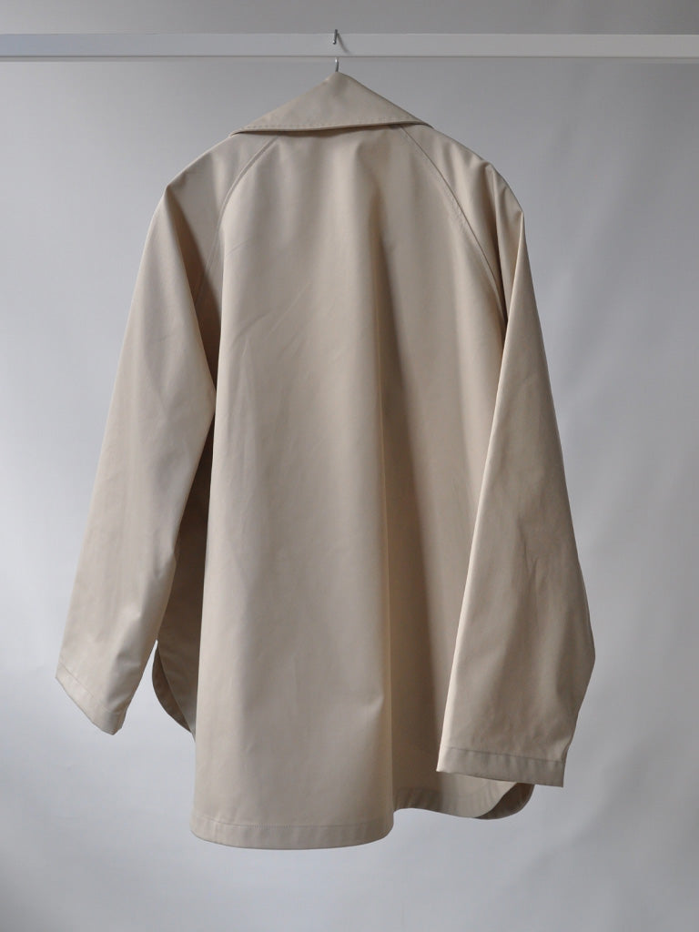 Back of Tea Trench Jacket in Beige on a hanger