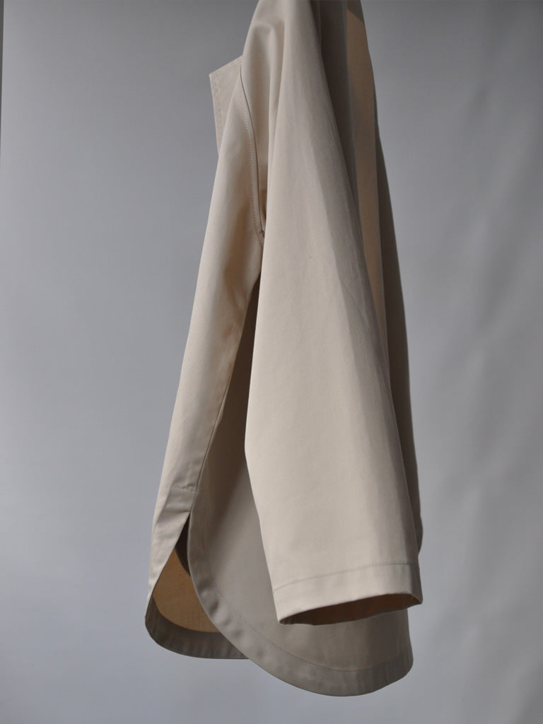 Side of Tea Trench Jacket in Beige on a hanger