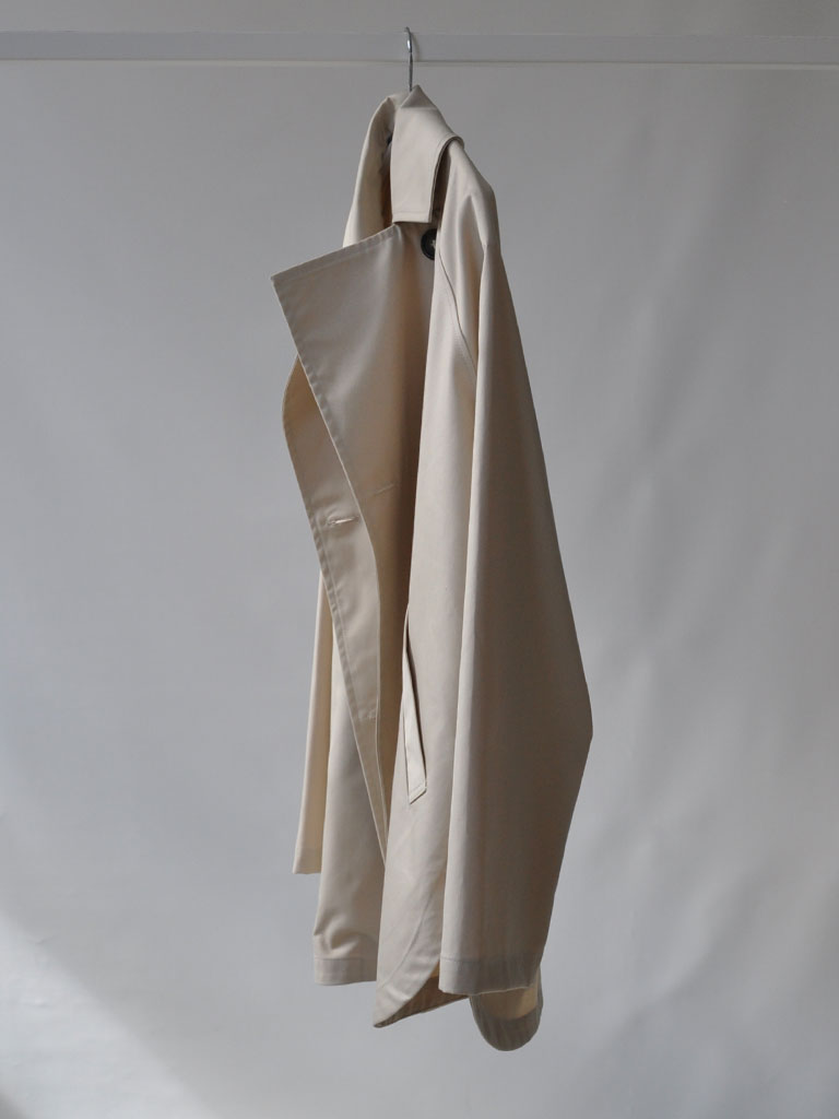 Side of Tea Trench Jacket in Beige on a hanger