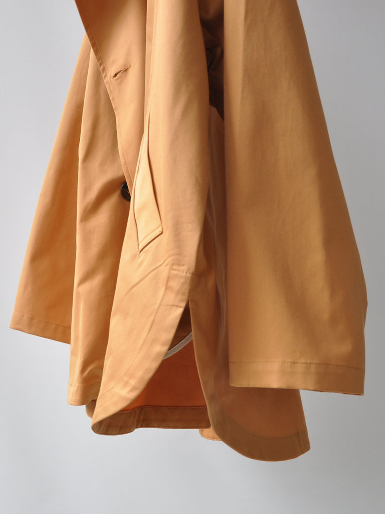 Side of Tea Trench Jacket in Burnt Orange on a hanger