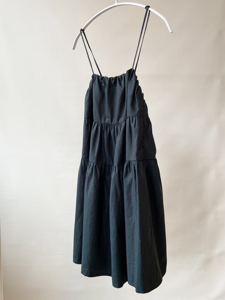 Side of Astis dress in black and green check