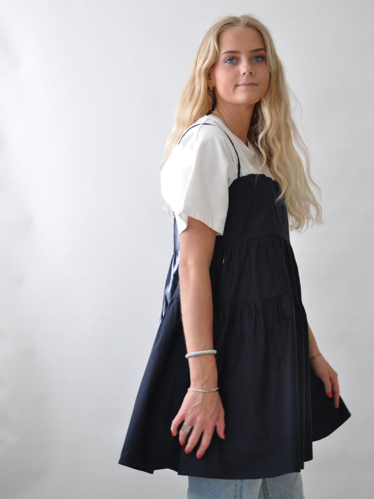 Astis dress in black blue check over a white tee