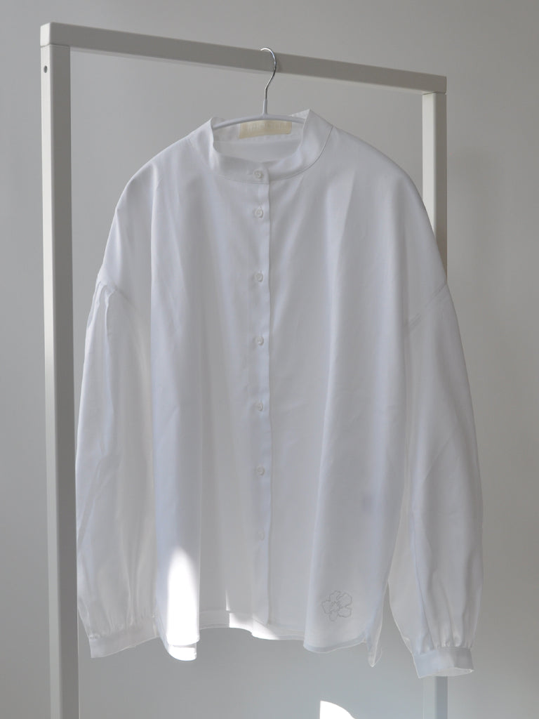 Front of Aude shirt in white on a hanger