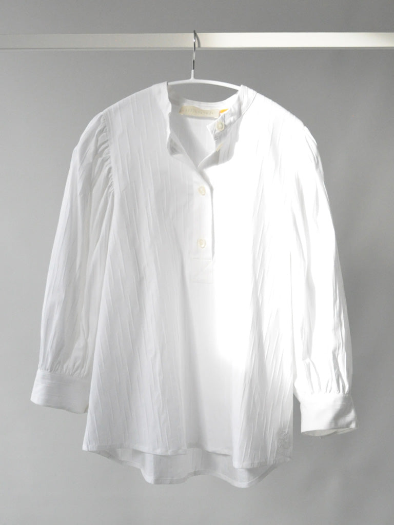 Front of Ava shirt in white on a hanger