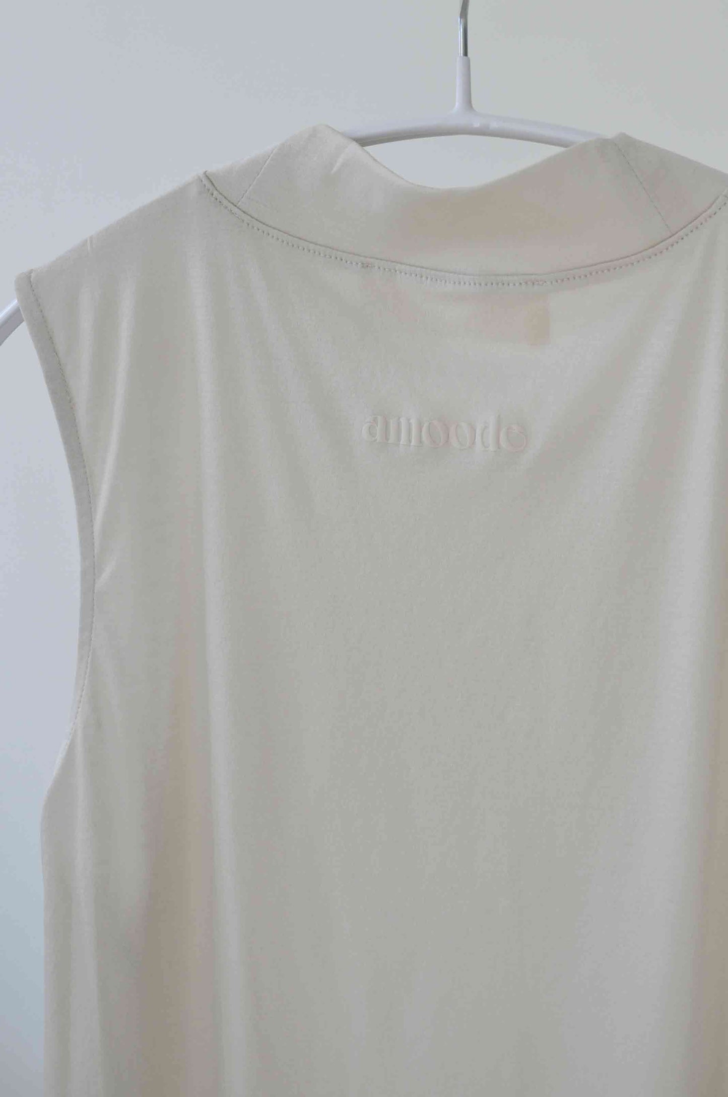 Back of Alanis Top in Soft Beige on a hanger