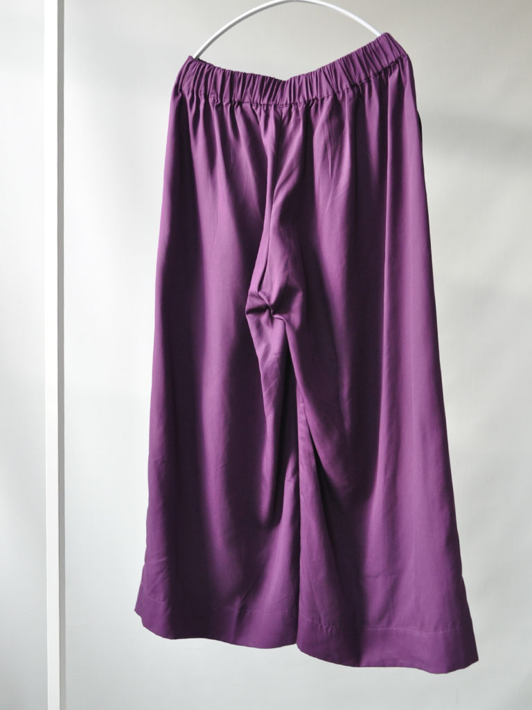 Back of Alea Pants in Purple Tencel on a hanger