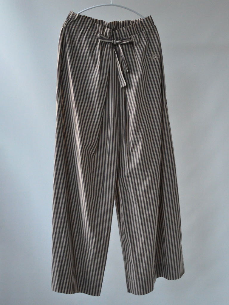 Front of Ami Pants in Stripes on a hanger