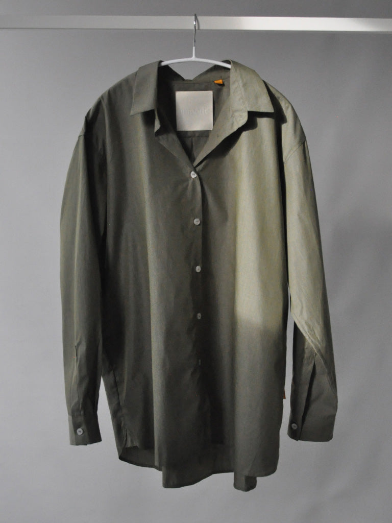 Front of Ana shirt in army green on a hanger