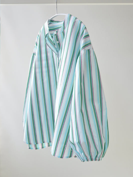 Side of Elli shirt in green stripes on a hanger